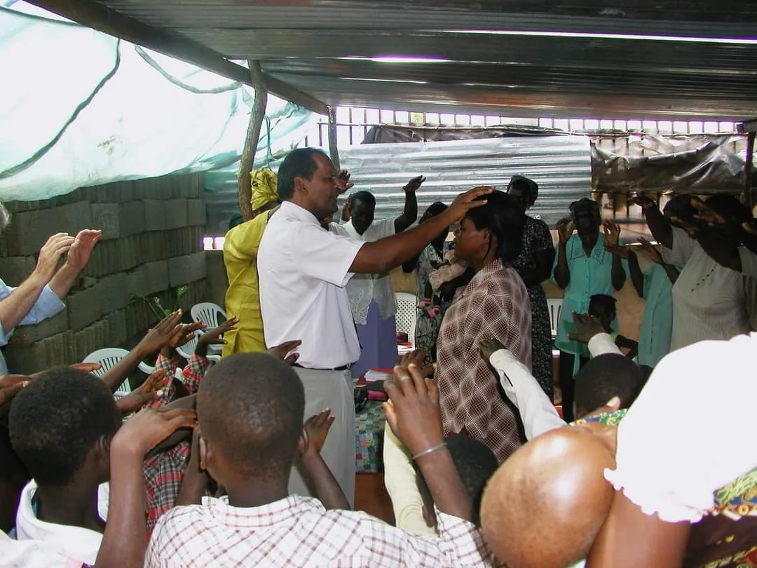 A congregation worshipping under a shelter in Mozambique